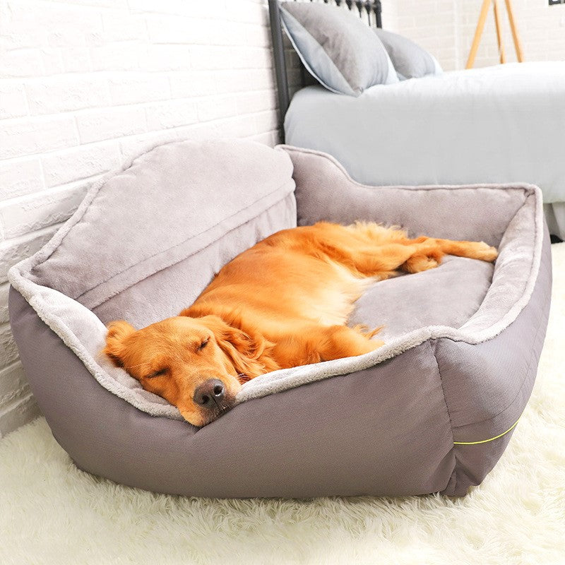 Dog lying on a grey pet bed in a cozy room.