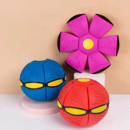 Three colorful dog toys with face-like designs on a beige background