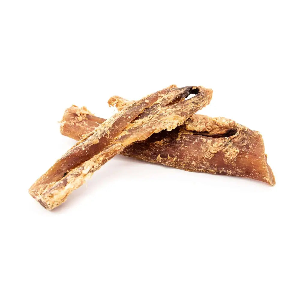 Two pieces of dried dog chew on a white background