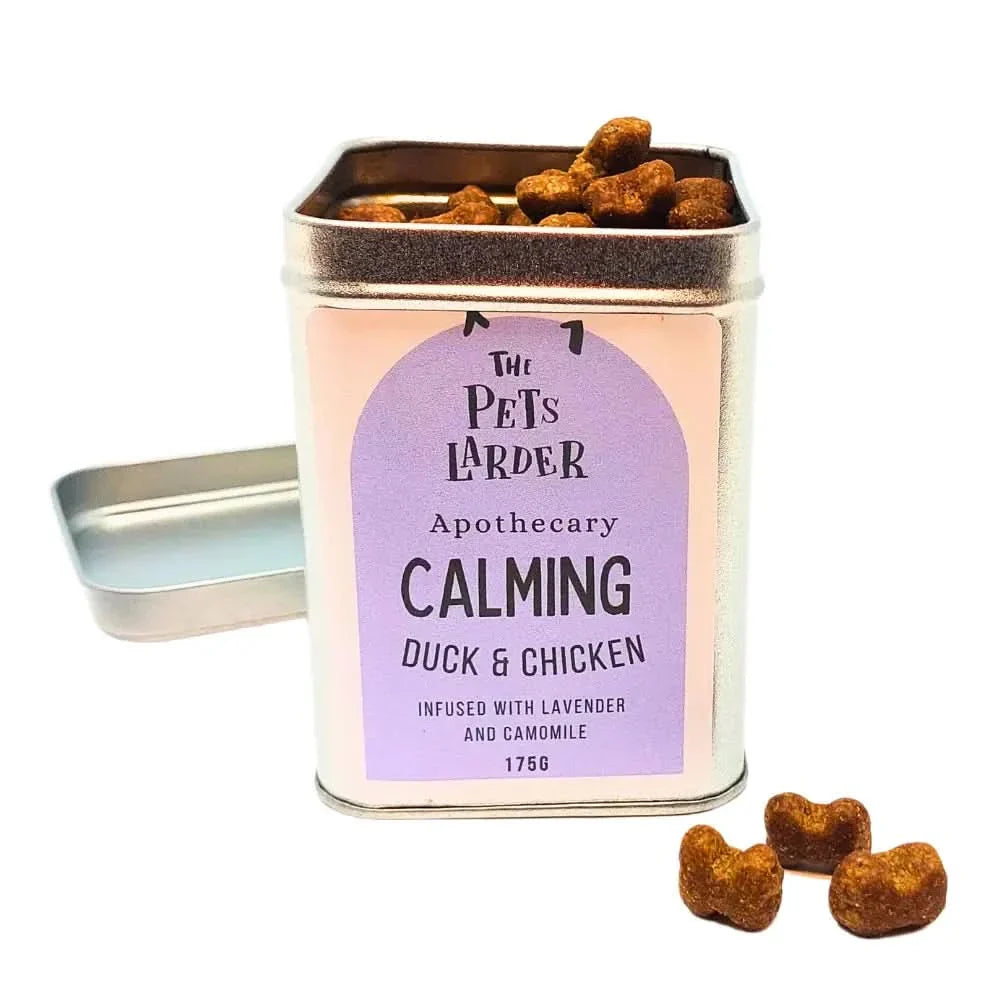 Tin of 'The Pet's Larder' calming duck & chicken treats with a purple label on a white background.