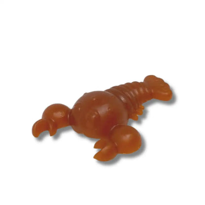 Orange lobster-shaped toy on a white background