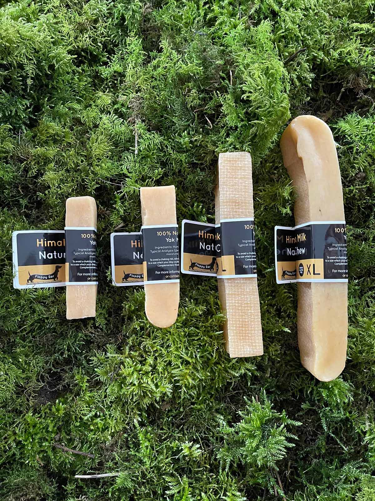Set of Himalayan salt products with packaging on a green moss background