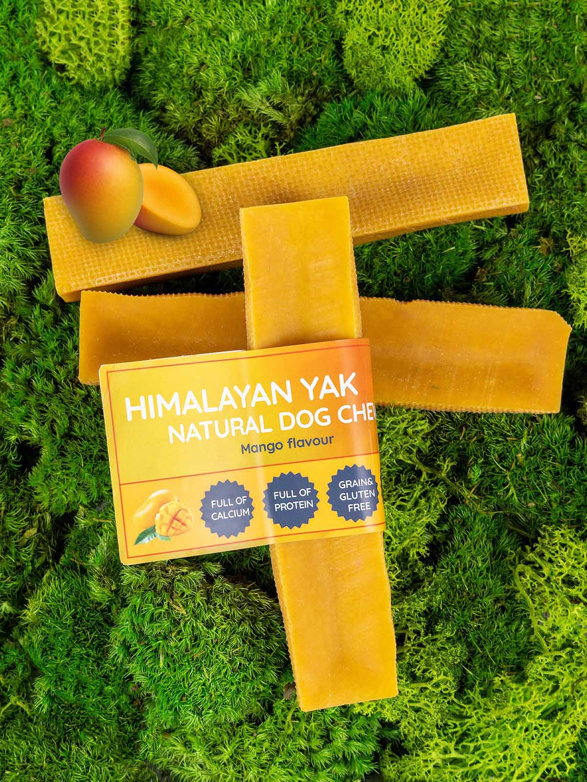 Himalayan Yak Natural Dog Chews with mango flavour on a grass background
