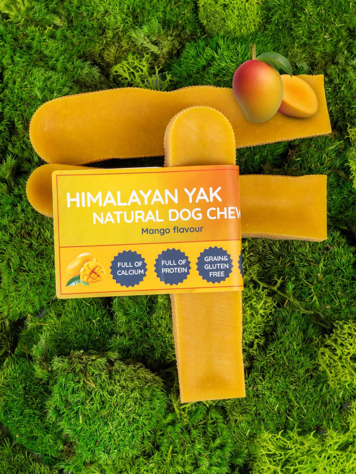 Himalayan Yak natural dog chew with mango flavour on a green grass background