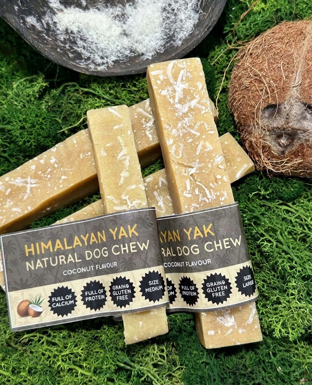 Himalayan Yak natural dog chews on a grassy background with a coconut.