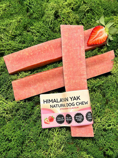 Strawberry flavour Himalayan Yak Milk Natural Dog Chew packaging with three pink chew sticks on grass.