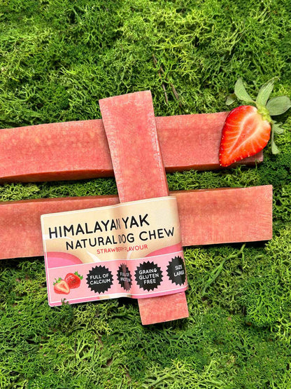 Strawberry flavour Himalayan Yak natural dog chew with strawberry flavor on a grass background