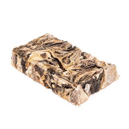 Bar of soap with brown and beige swirls on a white background