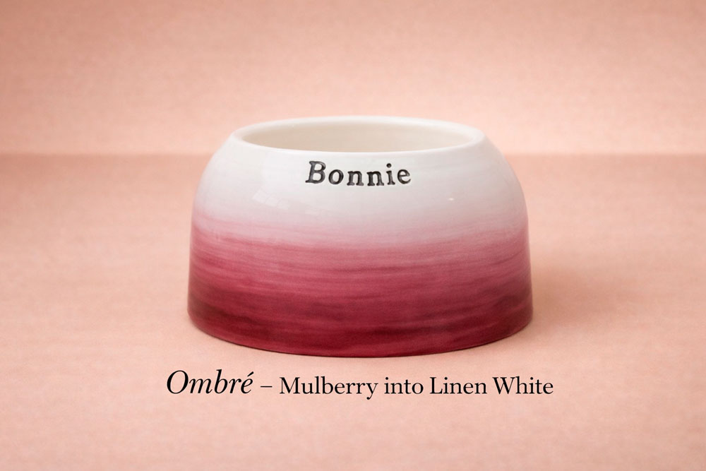 Ombre ceramic bowl transitioning from mulberry to linen white on a pink background