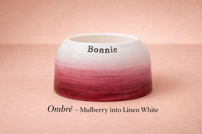 Ombre ceramic bowl transitioning from mulberry to linen white on a pink background