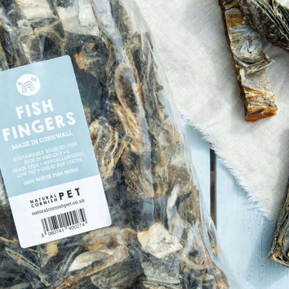 Dried fish fingers with a label indicating 'Fish Fingers Made in Cornwall' on a textured surface.