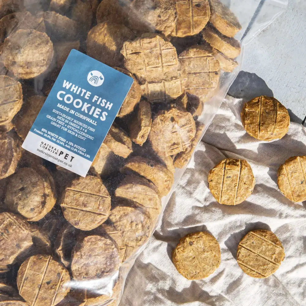 Dog treats with a label indicating 'White Fish Cookies' from Cornwall, UK.