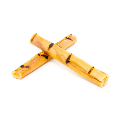 Two yellow dog chew toys with black spots on a white background