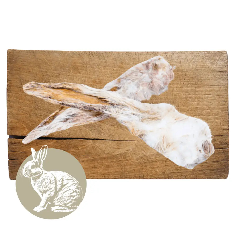 Two rabbit carcasses on a wooden cutting board with a small inset image of a rabbit.
