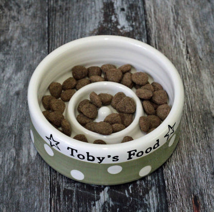 Pet food bowl with 'Toby's Food' label on a wooden surface