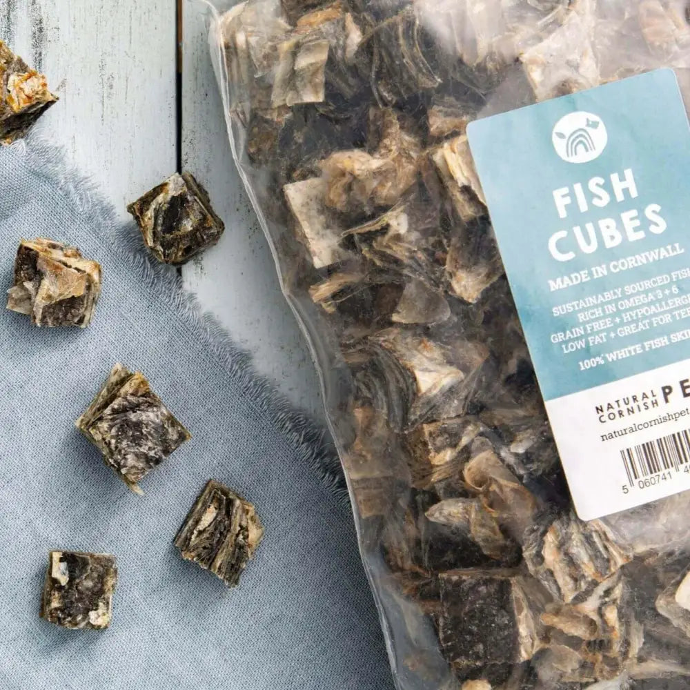 Packaged fish cubes with a label on a light blue surface