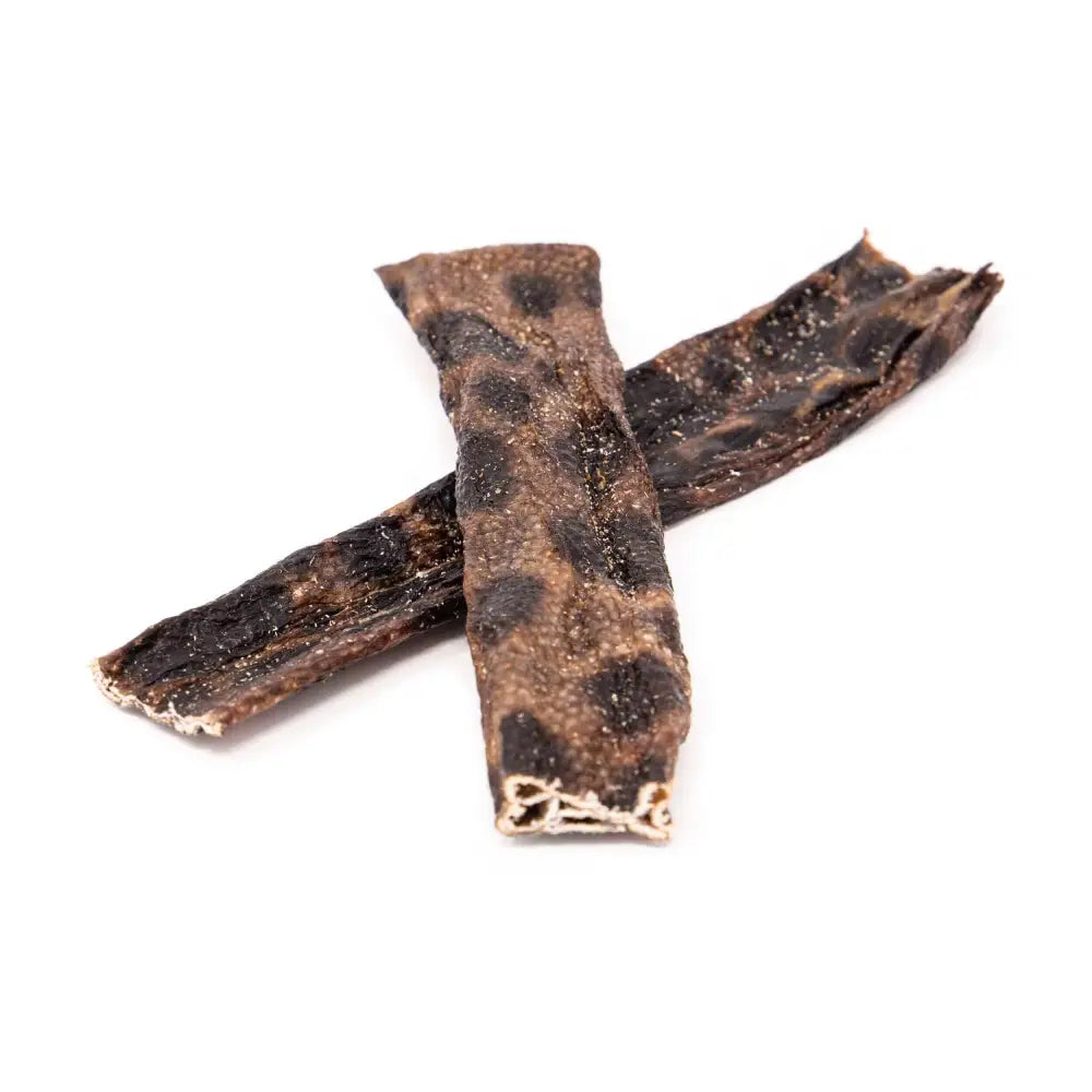 Two pieces of dried beef jerky on a white background