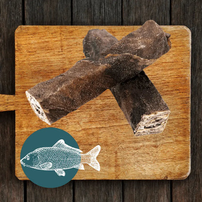 Dried fish on a wooden cutting board with a fish illustration in the corner.